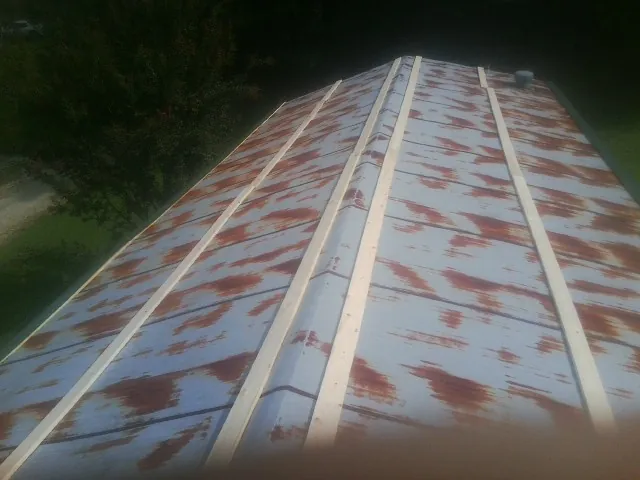 Rusted metal roof panels with new wood purlins before replacement — Storm Damage Roof Repair in Independence by Roofing Brothers